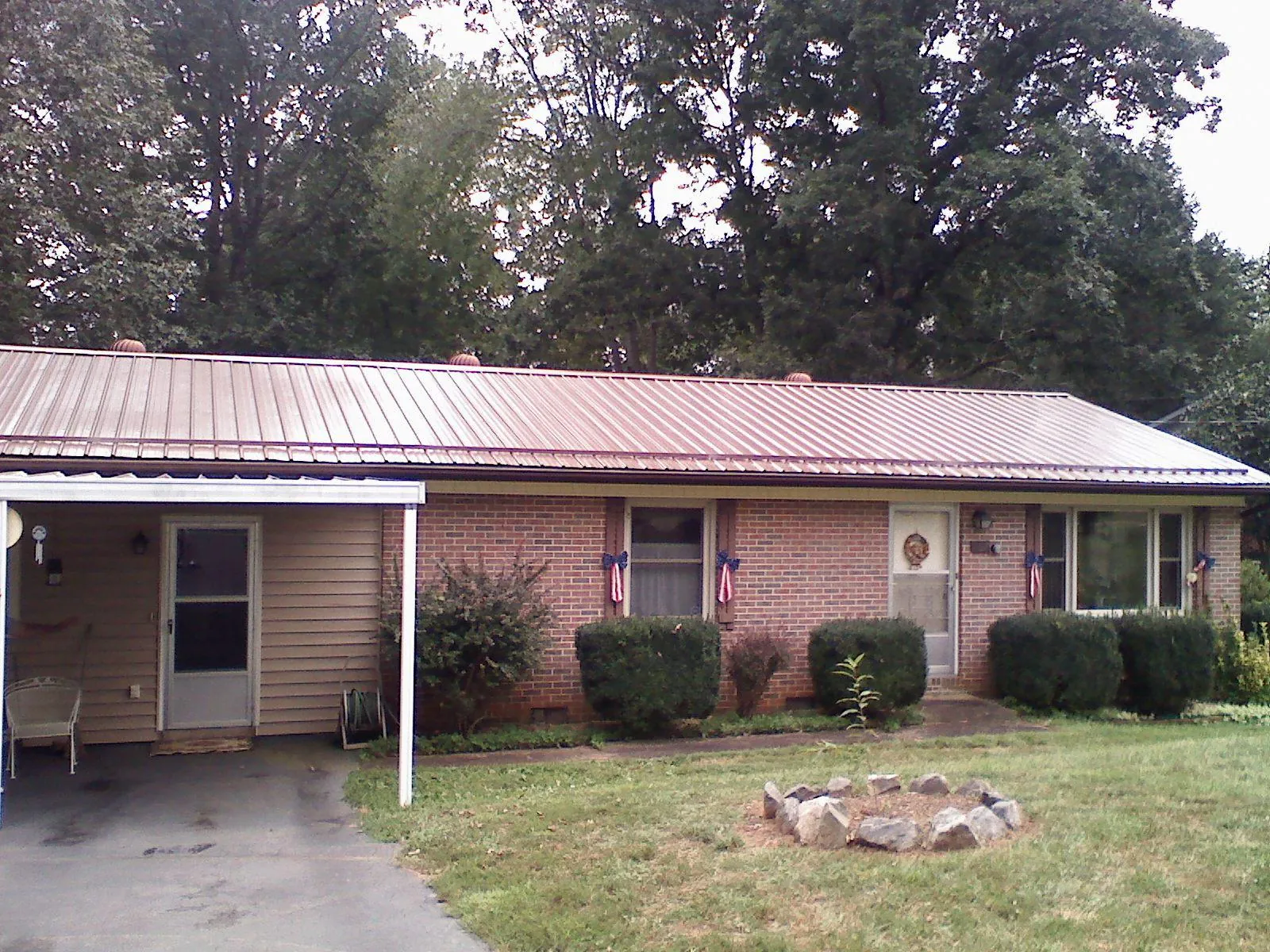 Bronze metal roof and carport on a brick ranch home — Roof Repair work by our crew in Tehama