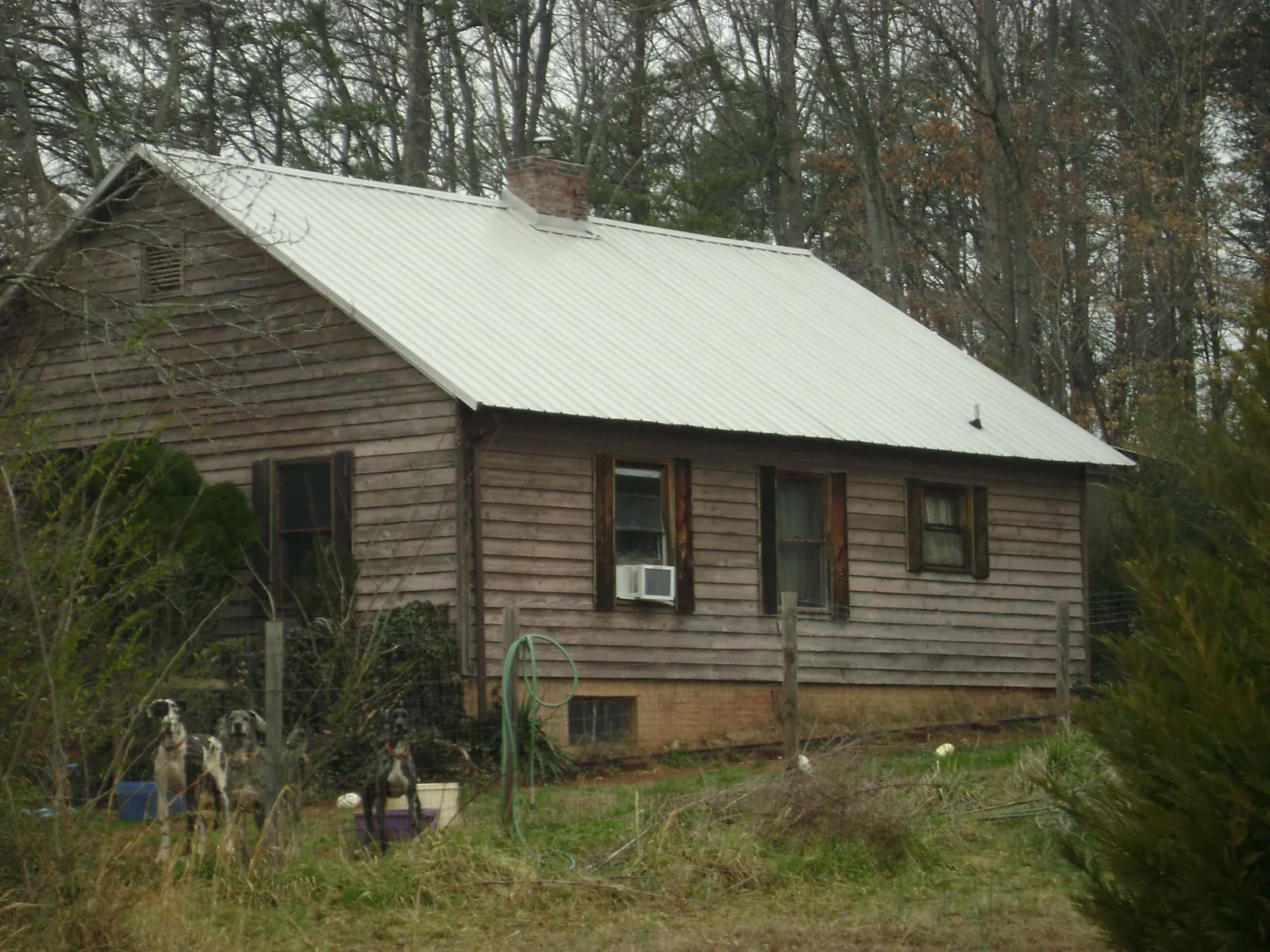 White metal roof on an old wood sided farmhouse, from a Metal Roof Installation job in Tehama